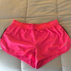 Bright pink Nike running shorts